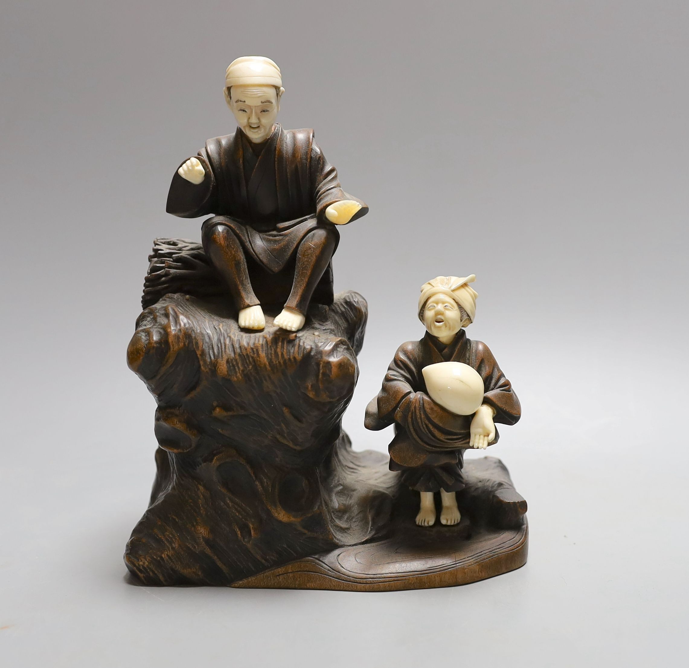 A Japanese ivory and wood figural okimono, Meiji period - 18.5cm tall